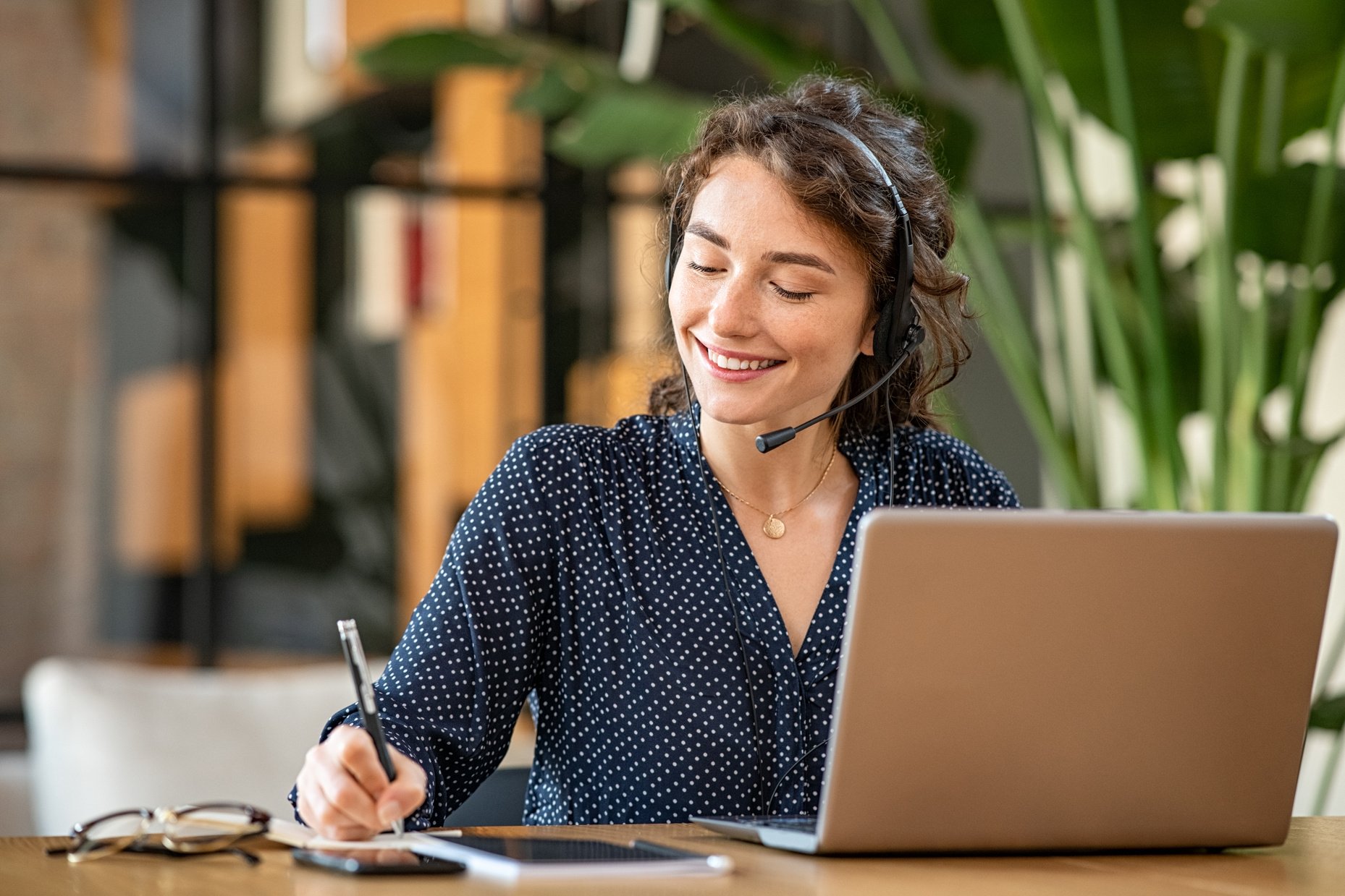 Successful customer service representative using laptop at office